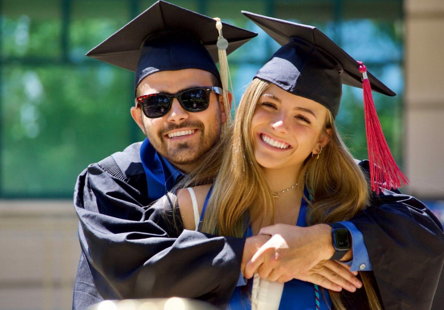 Competitive Rates for Every Need - Photo of two happy college graduates in their cap and gowns